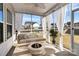 Relaxing screened porch with seating and fire pit at 7403 American Elm Rd, Charlotte, NC 28215