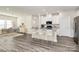 Virtually staged kitchen with island and white cabinets at 7403 American Elm Rd, Charlotte, NC 28215