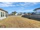 Spacious backyard with retaining wall and grassy area at 7403 American Elm Rd, Charlotte, NC 28215