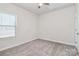 Small bedroom with a window and neutral walls at 7403 American Elm Rd, Charlotte, NC 28215