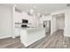 Open concept kitchen with island and white cabinets at 7403 American Elm Rd, Charlotte, NC 28215