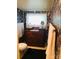 Small bathroom with floral wallpaper and antique dresser at 115 S Pearl St, Troy, NC 27371