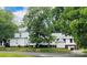 Two-story house with additions, mature trees, and a large yard at 115 S Pearl St, Troy, NC 27371