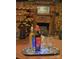 Wine bottles and glasses set on a tray in front of a fireplace at 115 S Pearl St, Troy, NC 27371