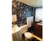 Small bathroom with floral wallpaper and antique vanity at 115 S Pearl St, Troy, NC 27371