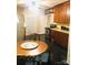 Kitchen with wood cabinets, stainless steel appliances, and a breakfast nook at 115 S Pearl St, Troy, NC 27371