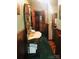 Hallway with antique furniture and green wallpaper at 115 S Pearl St, Troy, NC 27371
