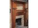 Ornate wooden fireplace mantel with stone surround at 115 S Pearl St, Troy, NC 27371