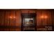 Wood paneled wall with painting and brass sconces at 115 S Pearl St, Troy, NC 27371