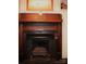 Elegant fireplace with a decorative mantle and gas logs at 115 S Pearl St, Troy, NC 27371