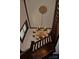 Elegant staircase with ornate chandelier and dark wood railings at 115 S Pearl St, Troy, NC 27371