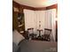 Charming bedroom with wood paneling and a cozy sitting area at 115 S Pearl St, Troy, NC 27371
