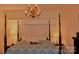 Main bedroom with a large four-poster bed and soft color scheme at 115 S Pearl St, Troy, NC 27371
