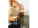 Kitchen features wood cabinets and a round dining table at 115 S Pearl St, Troy, NC 27371