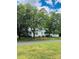 House exterior with mature trees and a large yard at 115 S Pearl St, Troy, NC 27371
