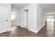 Spacious hallway with hardwood floors and white doors leading to other rooms at 4321 Stream Dale Nw Cir # 218, Concord, NC 28027