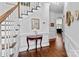 Entryway with hardwood floors, staircase, and decorative console table at 5303 Shasta Hill Ct, Charlotte, NC 28211