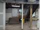 Unfinished basement with exposed beams, plumbing, and electrical wiring at 602 W Council St, Salisbury, NC 28144