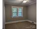 Bright bedroom with neutral walls, carpet, and large windows at 602 W Council St, Salisbury, NC 28144