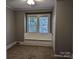 Bedroom with neutral walls, carpet, and built-in window seat at 602 W Council St, Salisbury, NC 28144