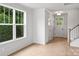 Bright entryway with shiplap walls, wood floors, and a view to the front door at 12243 Monteith Grove Dr, Huntersville, NC 28078