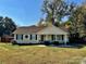 Charming yellow ranch home with a covered porch and well-manicured lawn at 950 Polk St, Charlotte, NC 28206