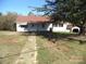 White single-story house with red roof, spacious yard, and detached shed at 5150 Goodman Lake Rd, Salisbury, NC 28146