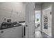Convenient laundry room with washer, dryer, and ample shelving at 12129 Storm Ln # 58, Charlotte, NC 28277