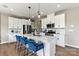 Modern kitchen with white cabinets, stainless steel appliances, and a large island at 15002 Caspian Way, Charlotte, NC 28278