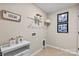 Laundry room with shelving, dog bowls, and pet door at 15002 Caspian Way, Charlotte, NC 28278