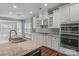 Kitchen boasts white cabinetry, stainless steel appliances, and granite countertops at 2714 Stonewood Vw, Kannapolis, NC 28081