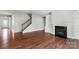 Living room featuring hardwood floors, a fireplace, built-in shelving, and a staircase at 2714 Stonewood Vw, Kannapolis, NC 28081