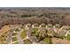 Aerial perspective of a suburban community with homes, streets, and surrounding trees at 2714 Stonewood Vw, Kannapolis, NC 28081