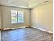 Bedroom with window, wood-look flooring, and vaulted ceiling at 3216 Irwin Valley Ct, Charlotte, NC 28269