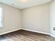 Well-lit bedroom featuring wood-look flooring and a window at 3216 Irwin Valley Ct, Charlotte, NC 28269