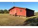 Large red barn with a gabled roof and a door at 16409 Silver Rd, Oakboro, NC 28129