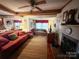 Cozy living room featuring a fireplace, comfy sofa, and large windows at 16409 Silver Rd, Oakboro, NC 28129