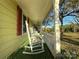 Front porch with white rocking chairs and view of the yard at 16409 Silver Rd, Oakboro, NC 28129