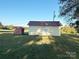Two storage sheds on the property, one red and one light yellow at 16409 Silver Rd, Oakboro, NC 28129