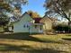 A yellow house with a red roof, covered porch, and nice lawn at 16409 Silver Rd, Oakboro, NC 28129