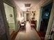 A charming hallway with vintage wallpaper, two armchairs, and access to other rooms at 16409 Silver Rd, Oakboro, NC 28129
