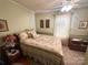Cozy bedroom with floral bedding, nightstand, and ceiling fan at 16409 Silver Rd, Oakboro, NC 28129