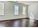 Well-lit bedroom featuring three windows with blinds and dark brown flooring at 1007 Silverwood Dr, Waxhaw, NC 28173