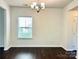 Bright dining room with dark hardwood floors and a chandelier at 1007 Silverwood Dr, Waxhaw, NC 28173