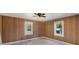 Bedroom with wood paneled walls and ceiling fan at 127 E Branch Ave, Shelby, NC 28152