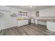 White kitchen cabinets, gray vinyl flooring at 127 E Branch Ave, Shelby, NC 28152