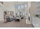 Two-story living room with a fireplace and lots of natural light at 9440 Wallace Pond Dr, Huntersville, NC 28078