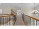 Upstairs hallway with hardwood floors and railing at 9440 Wallace Pond Dr, Huntersville, NC 28078