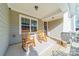 Relaxing front porch with rocking chairs, providing a welcoming entryway at 7002 Kingfisher Way, Belmont, NC 28012