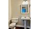 Simple bathroom with pedestal sink and dark floors at 7915 Willows Pond Ct, Charlotte, NC 28277